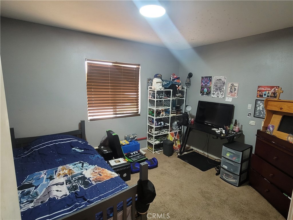 11930 Poppy Road Adelanto, CA 92301 - Photo 17 of 22 a livingroom with workspace and a window