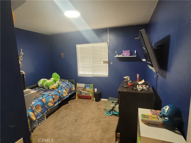 a bedroom with bed and a couch