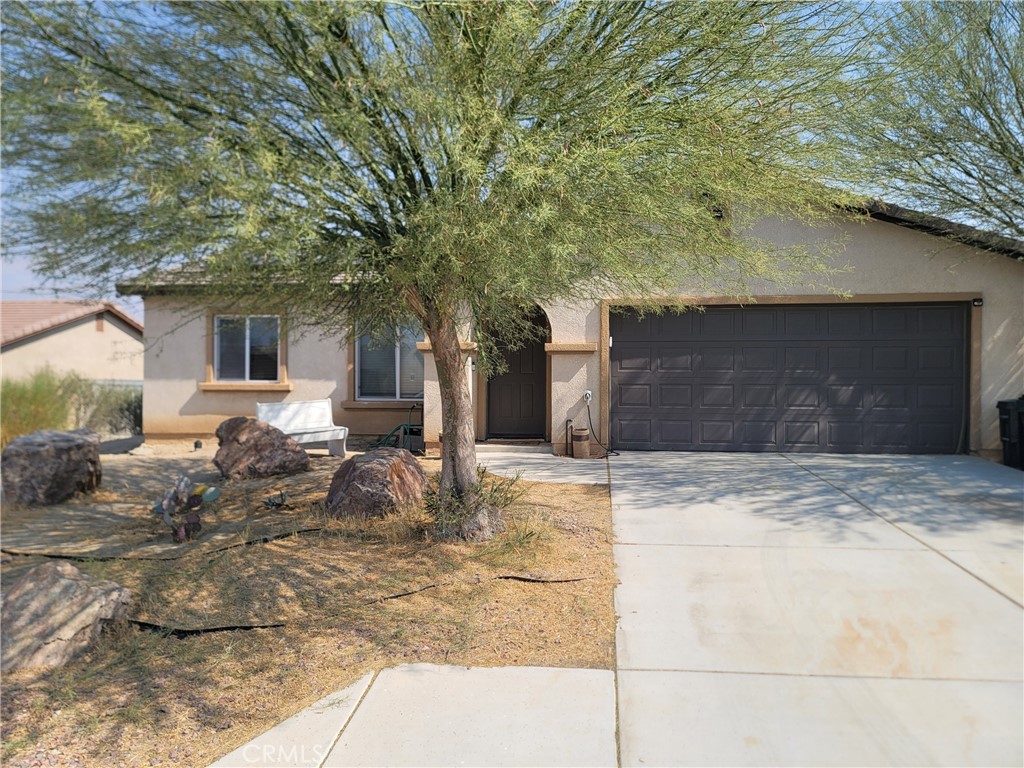 11930 Poppy Road Adelanto, CA 92301 - Photo 2 of 22 a view of a house with a yard