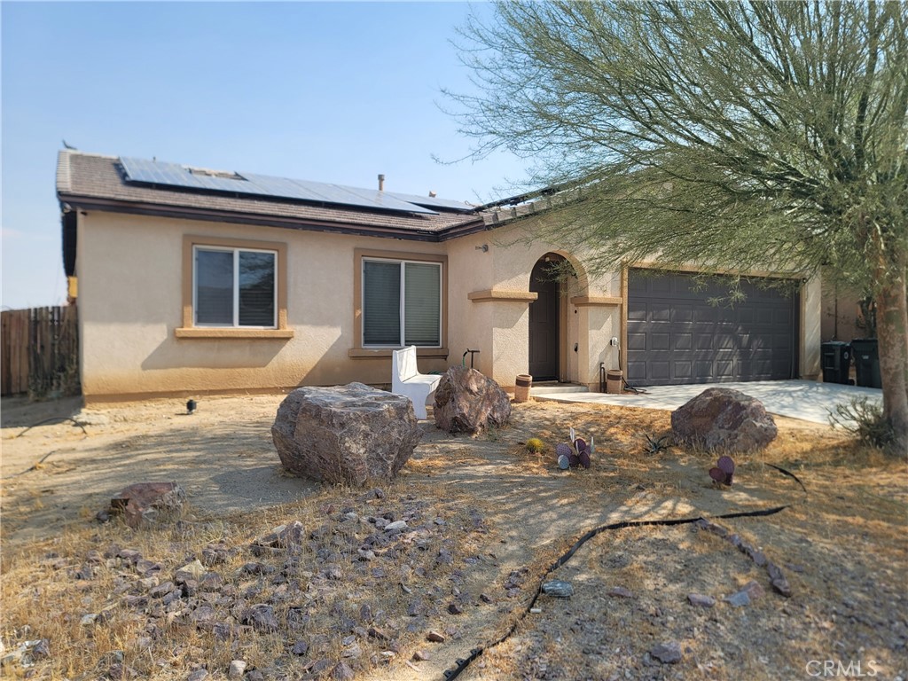 11930 Poppy Road Adelanto, CA 92301 - Photo 4 of 22 a view of a house with a yard