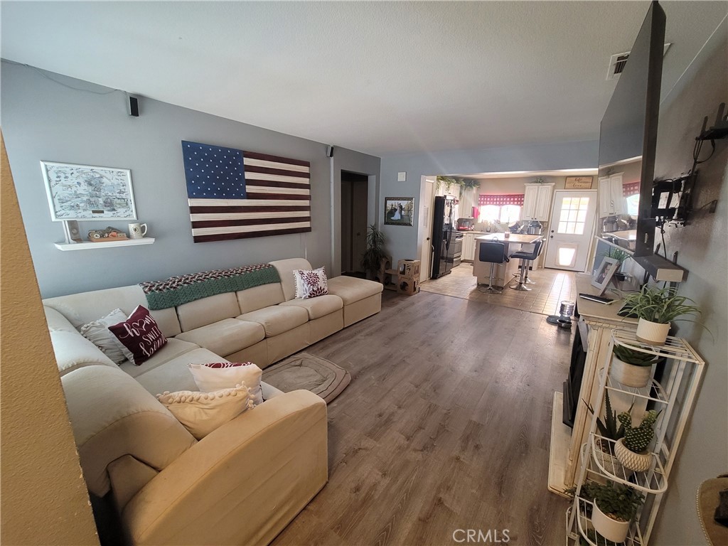 11930 Poppy Road Adelanto, CA 92301 - Photo 5 of 22 a living room with furniture and a flat screen tv