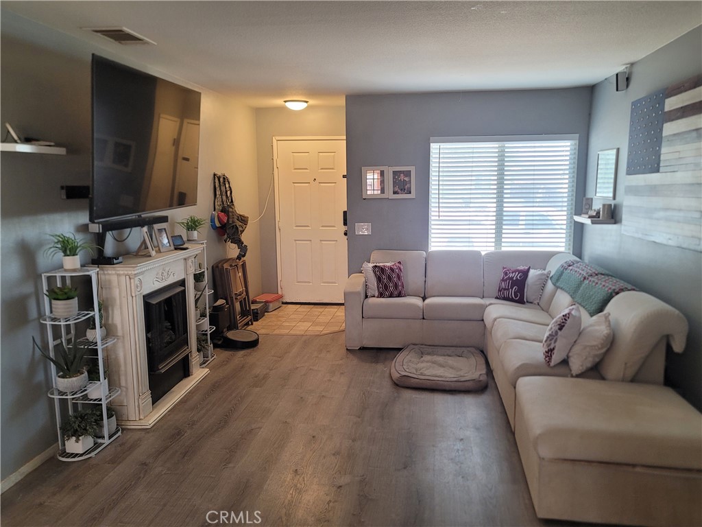11930 Poppy Road Adelanto, CA 92301 - Photo 6 of 22 a living room with furniture and a fireplace