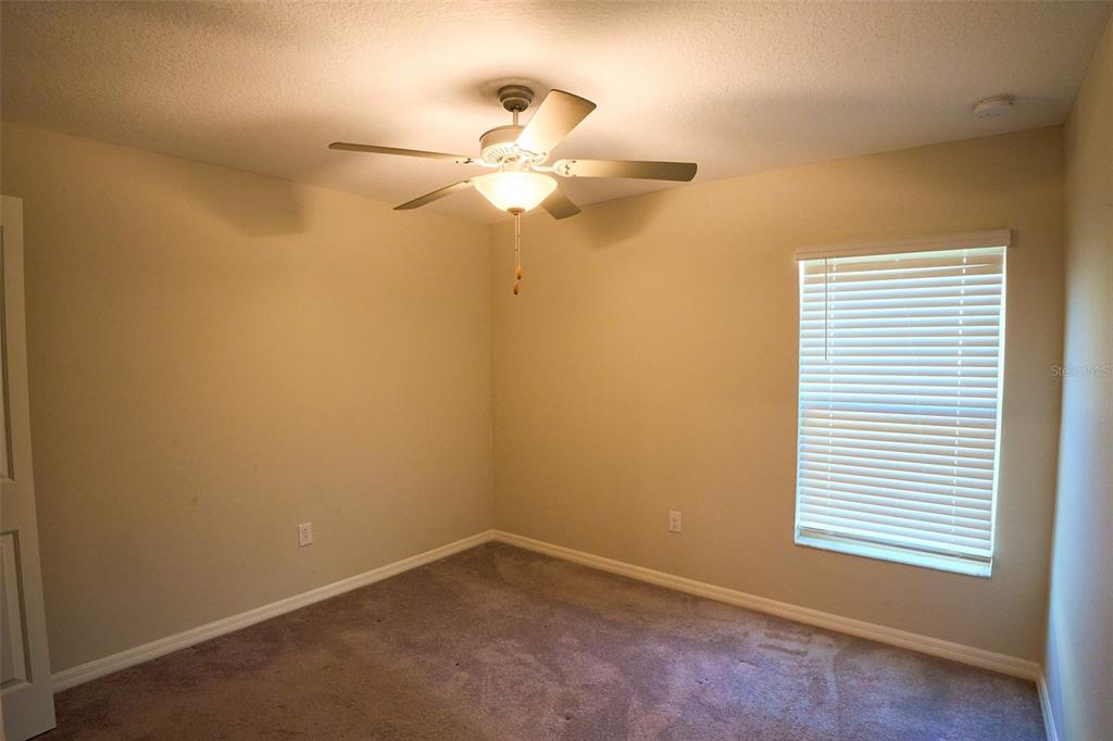 13351 Willow Bluestar Loop Riverview, FL 33579 - Photo 12 of 15 an empty room with a window and a fan