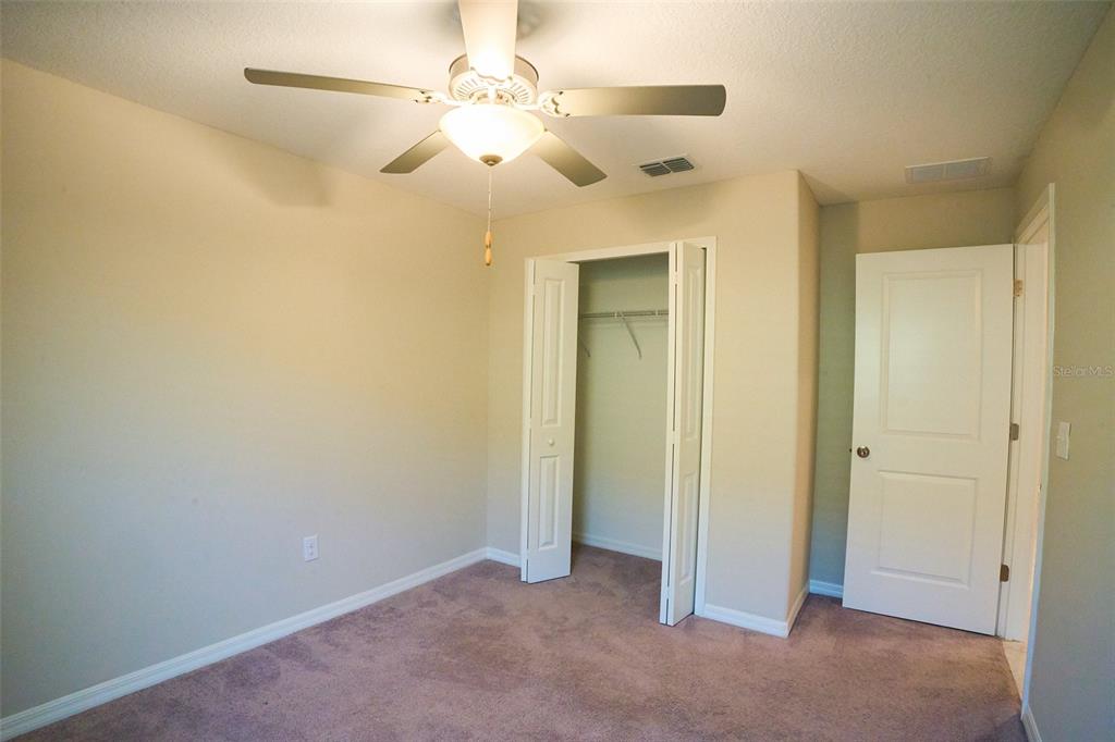 13351 Willow Bluestar Loop Riverview, FL 33579 - Photo 14 of 15 an empty room with chandelier fan