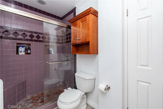 a bathroom with a toilet and a shower