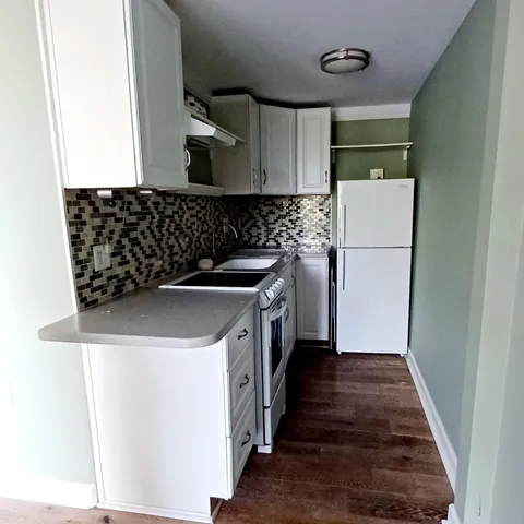 a utility room with sink washer and dryer