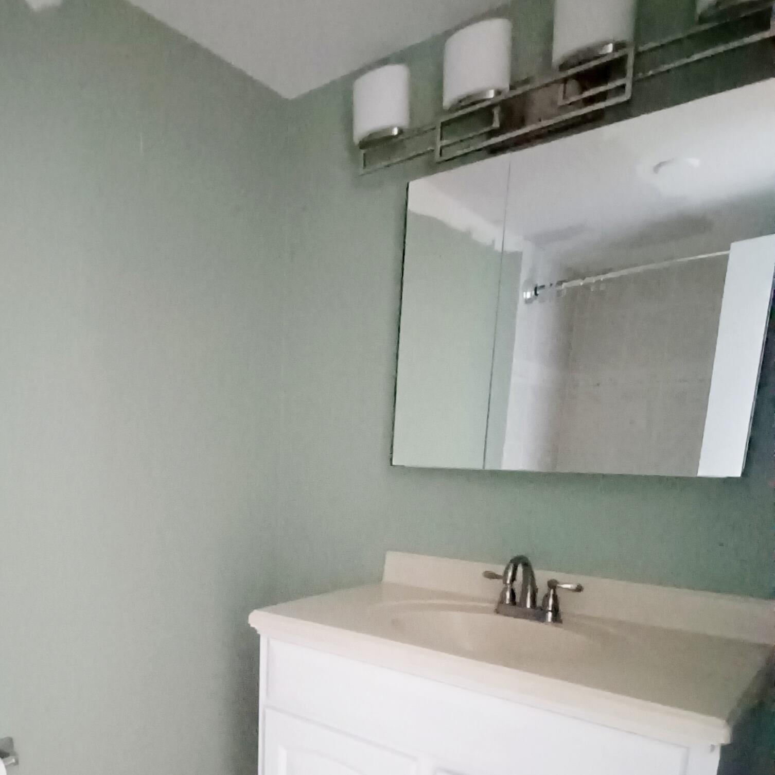 15 South Golfview Road, Unit 303 Lake Worth Beach, FL 33460 - Photo 9 of 10 a bathroom with a sink and a mirror