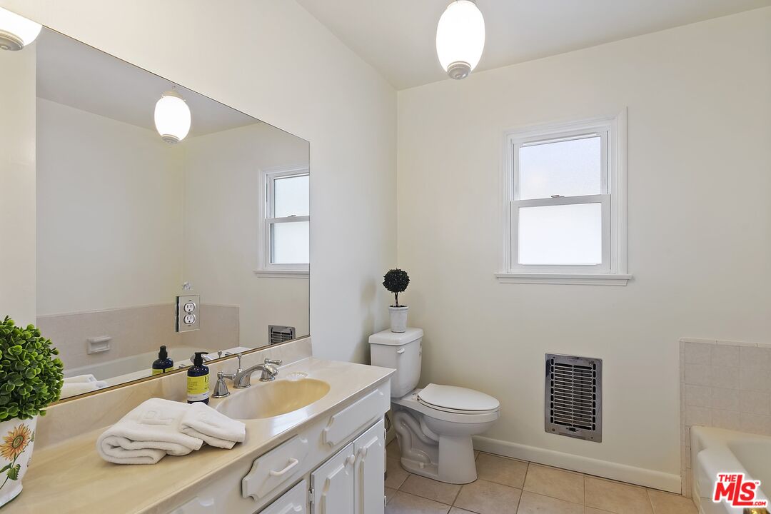11357 Gladwin Street Los Angeles, CA 90049 - Photo 11 of 15 a bathroom with a sink a toilet and mirror