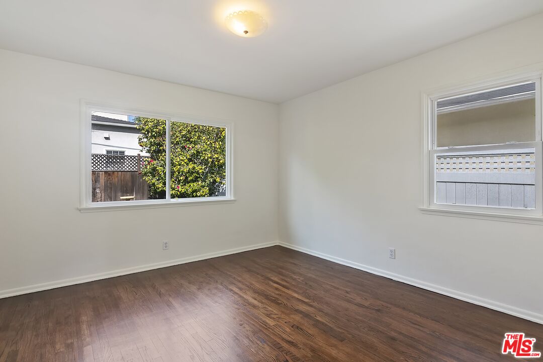 11357 Gladwin Street Los Angeles, CA 90049 - Photo 12 of 15 a view of an empty room with wooden floor and a window