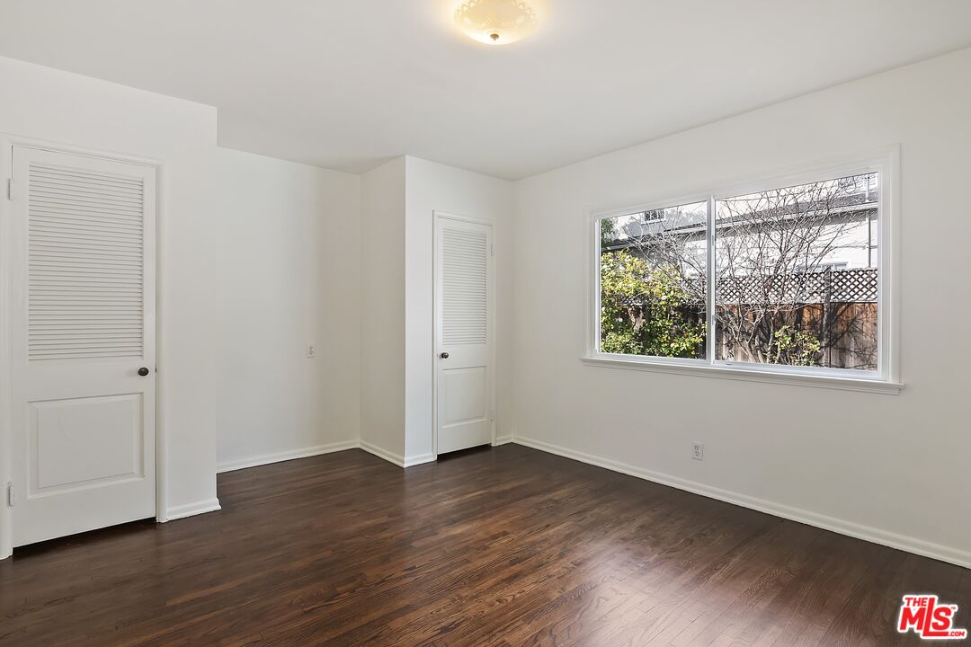 11357 Gladwin Street Los Angeles, CA 90049 - Photo 13 of 15 a view of an empty room with wooden floor and a window
