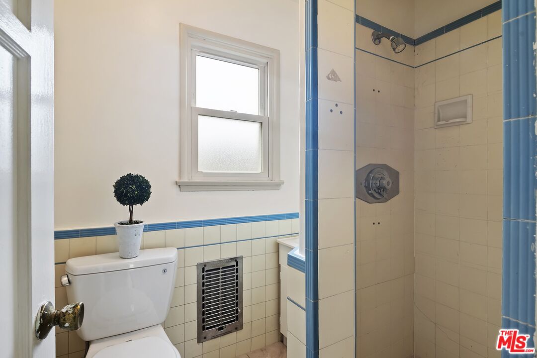 11357 Gladwin Street Los Angeles, CA 90049 - Photo 15 of 15 a bathroom with a toilet a sink and a window