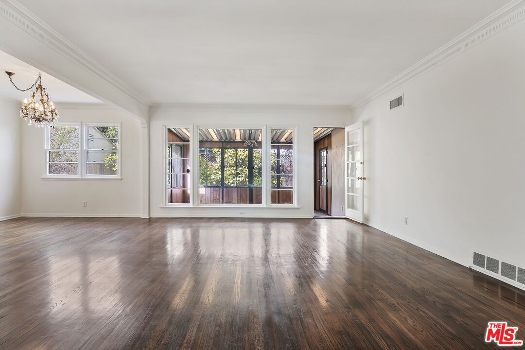 11357 Gladwin Street Los Angeles, CA 90049 - Photo 3 of 15 a view of an empty room with wooden floor and a window