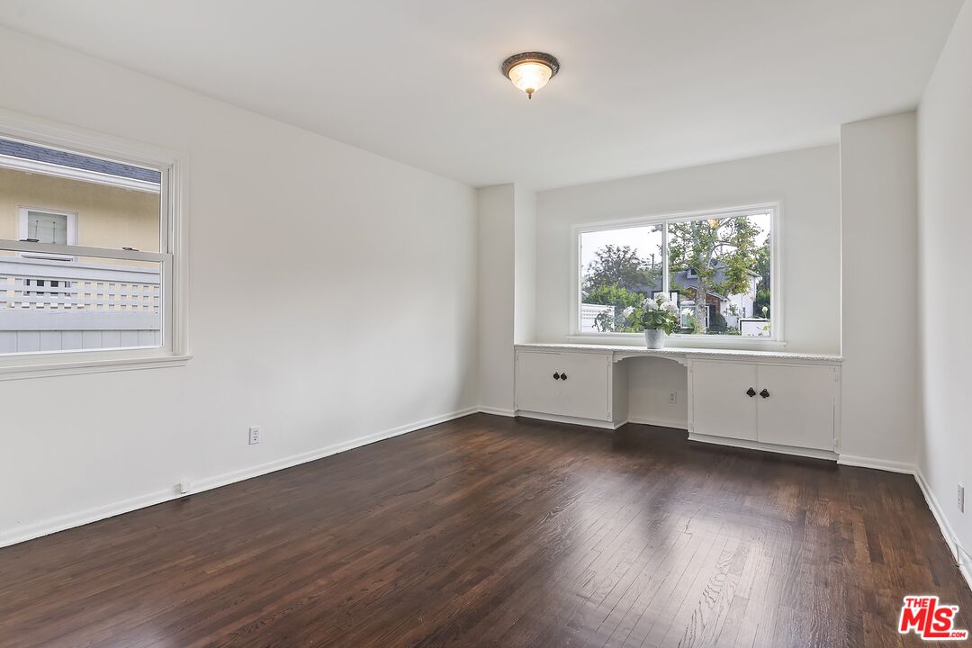 11357 Gladwin Street Los Angeles, CA 90049 - Photo 9 of 15 an empty room with wooden floor and windows