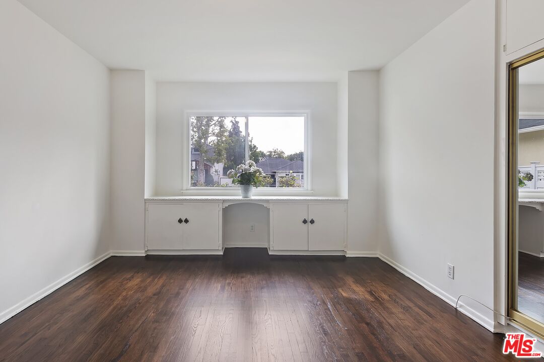 11357 Gladwin Street Los Angeles, CA 90049 - Photo 10 of 15 an empty room with wooden floor and windows