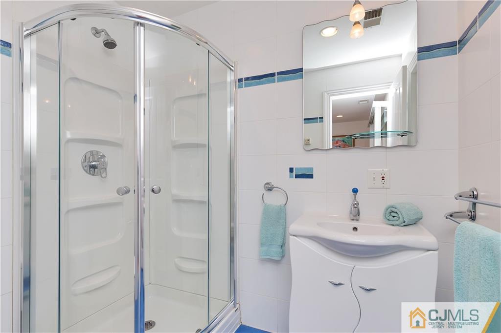 92 Union Valley Road Monroe Township, NJ 08831 - Photo 21 of 23 a bathroom with a shower sink and mirror
