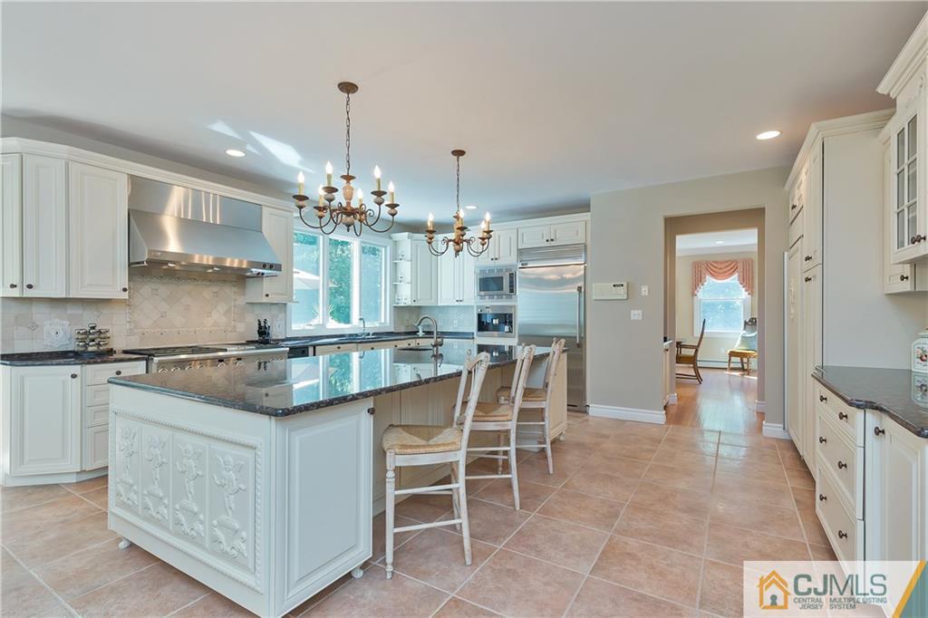 92 Union Valley Road Monroe Township, NJ 08831 - Photo 10 of 23 a kitchen with kitchen island granite countertop lots of counter top space and stainless steel appliances