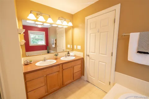 a bathroom with a double vanity sink and mirror