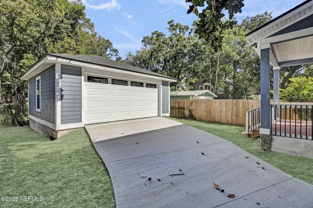 a view of a backyard with a small cabin and wooden fence