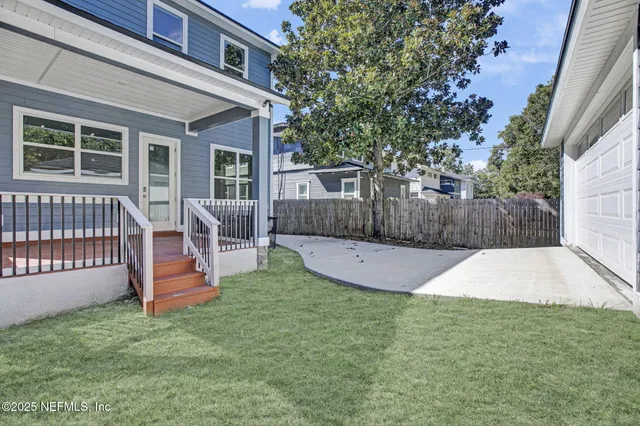 a view of a wooden deck and a yard