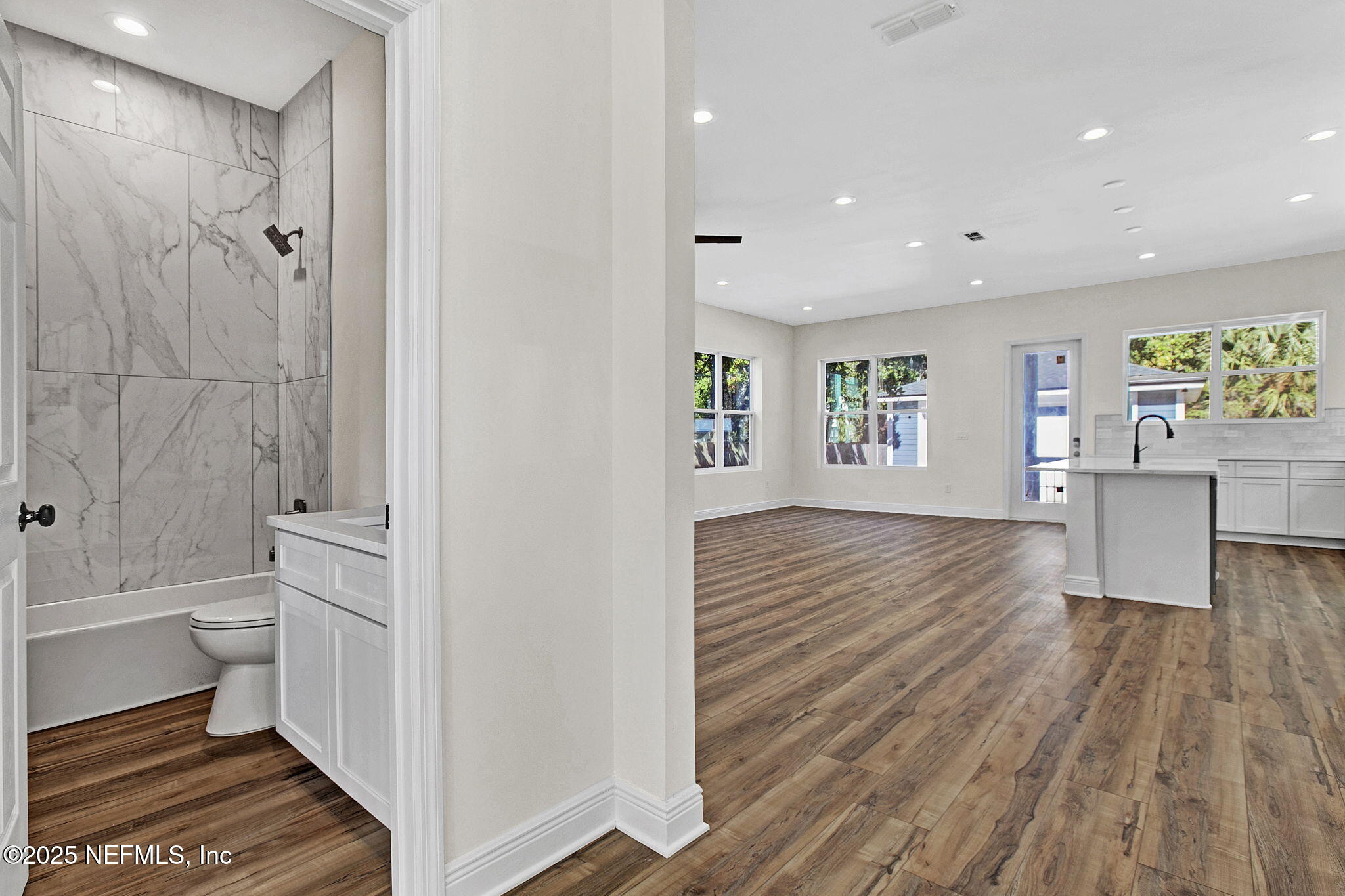 2841 Post Street Jacksonville, FL 32205 - Photo 19 of 40 a view of a bathroom with bathtub wooden floor and windows