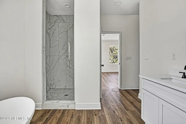 a white bath tub sitting next to a shower