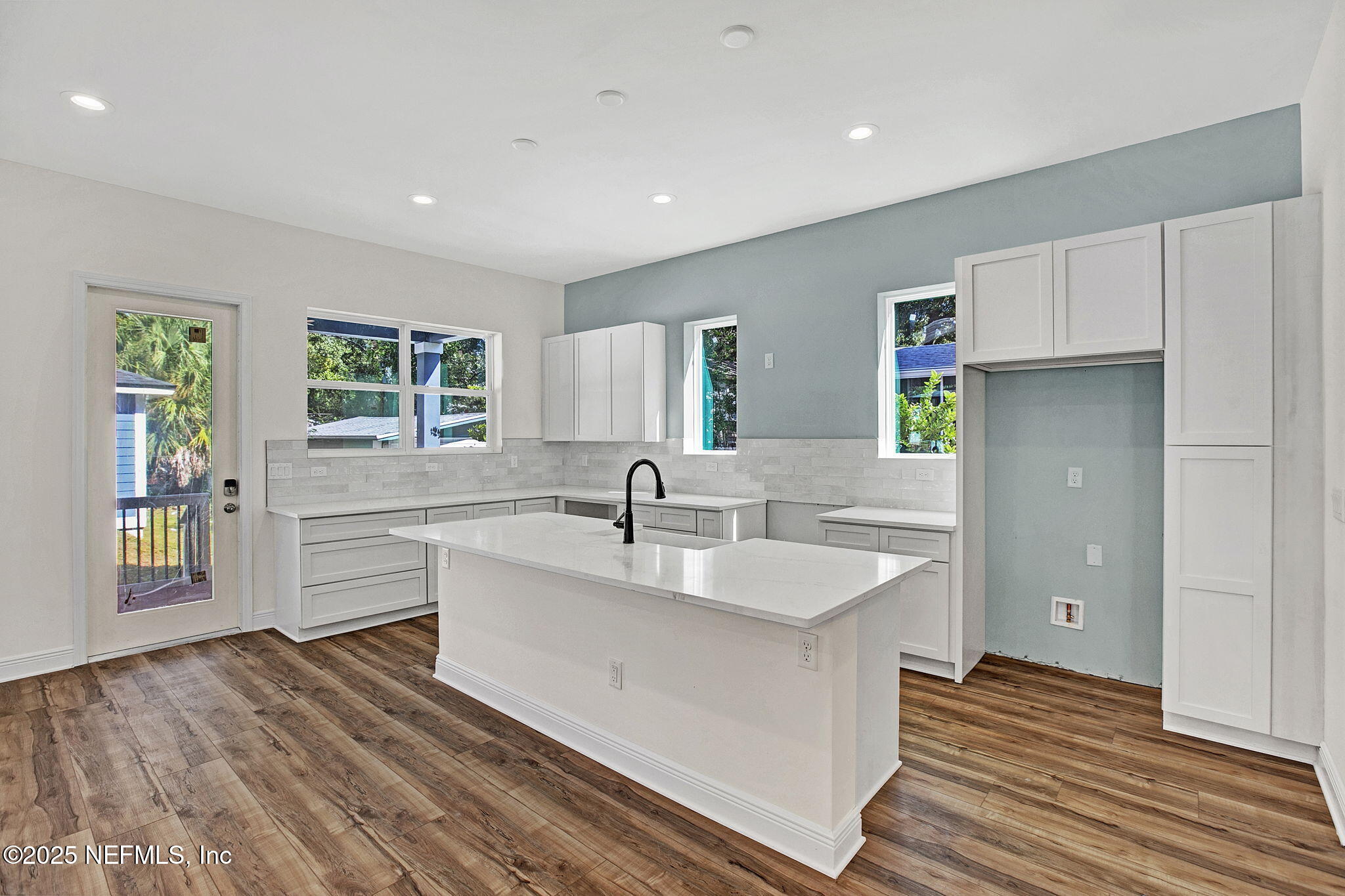 2841 Post Street Jacksonville, FL 32205 - Photo 33 of 40 a large white kitchen with wooden floor and a window