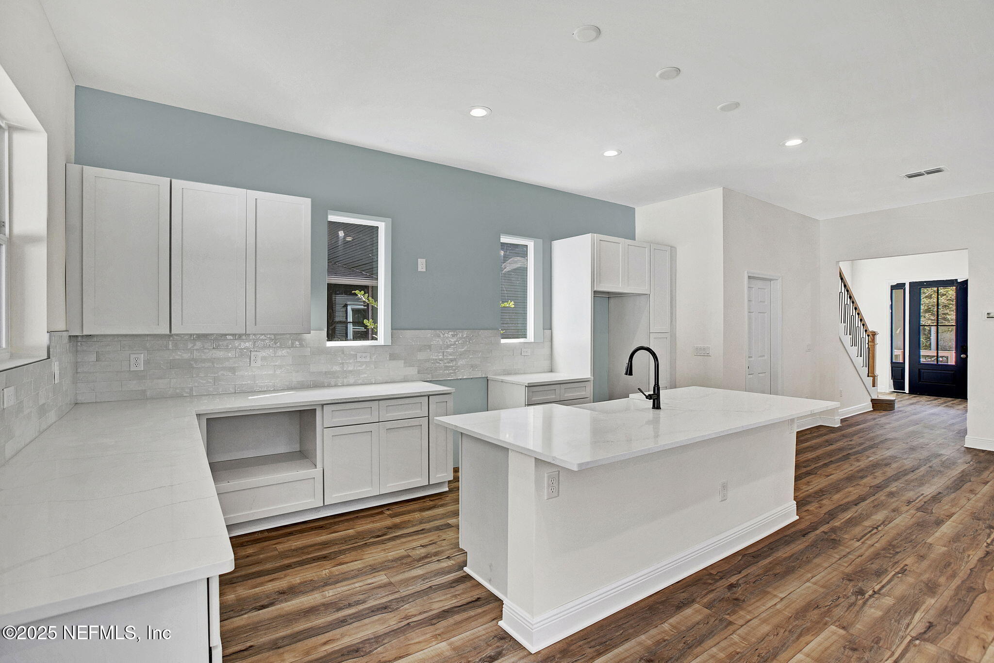 2841 Post Street Jacksonville, FL 32205 - Photo 34 of 40 a large white kitchen with a sink and dishwasher with wooden floor