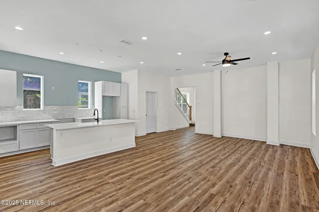 a large white kitchen with a white countertops and cabinets