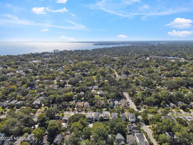 an aerial view of residential houses with city view