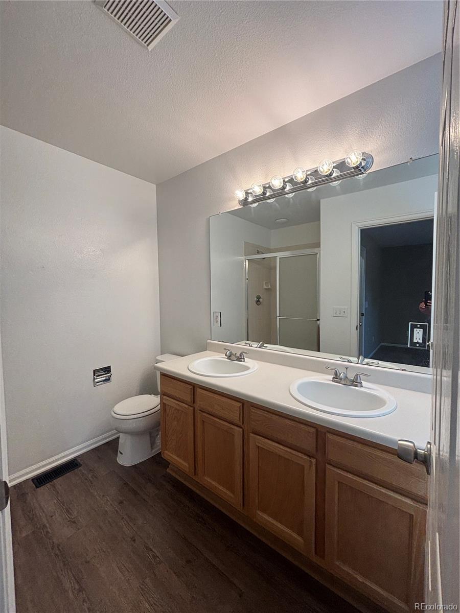 1281 Riddlewood Road Highlands Ranch, CO 80129 - Photo 15 of 27 a bathroom with a double vanity sink and a mirror