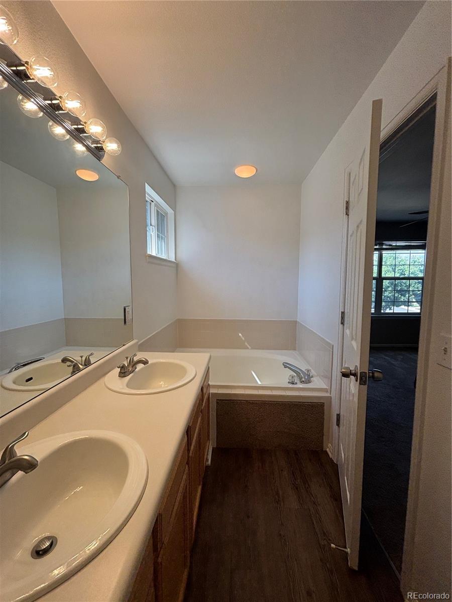 1281 Riddlewood Road Highlands Ranch, CO 80129 - Photo 16 of 27 a bathroom with a tub sink and mirror