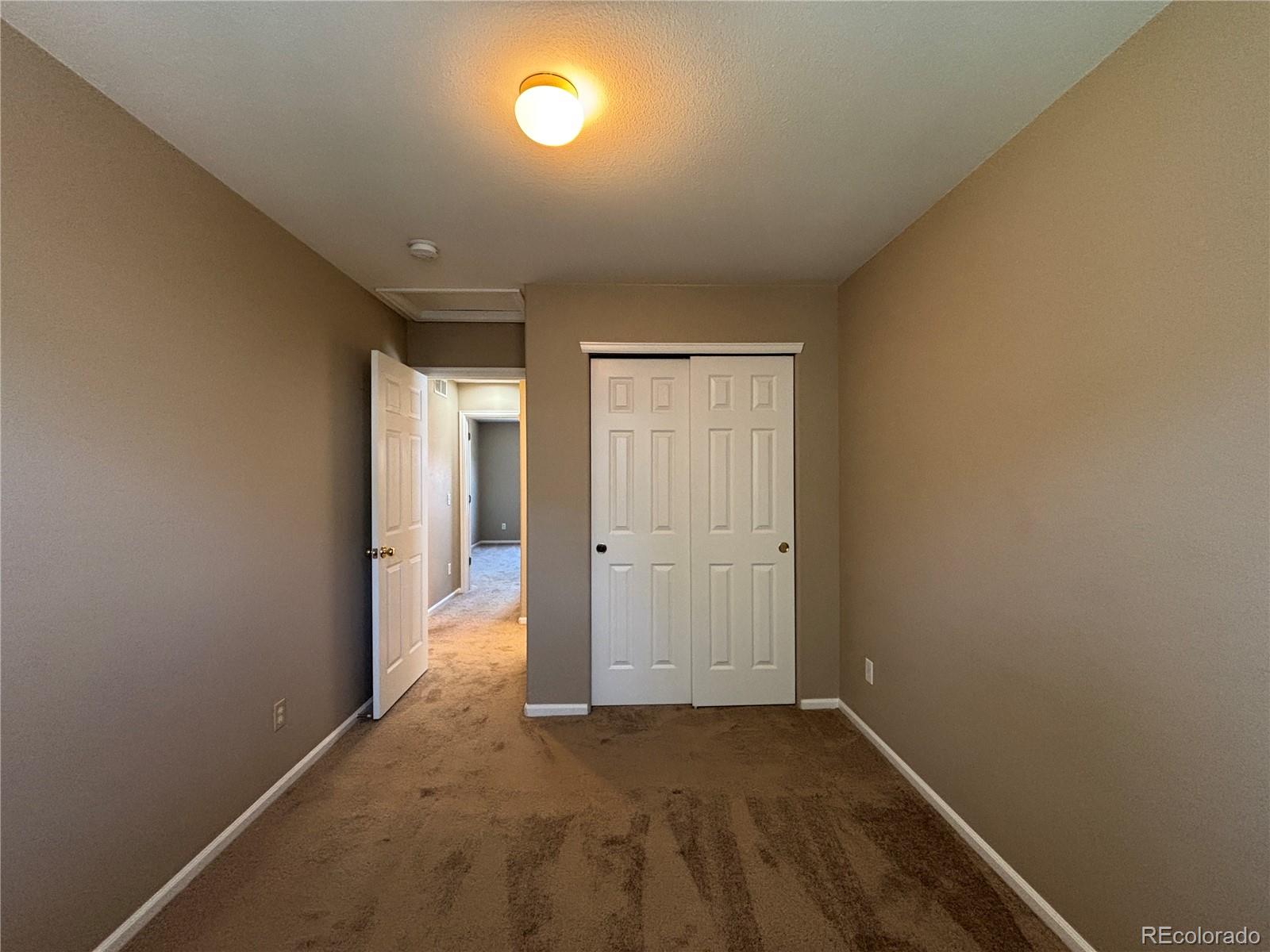 1281 Riddlewood Road Highlands Ranch, CO 80129 - Photo 18 of 27 an empty room with wooden floor and windows