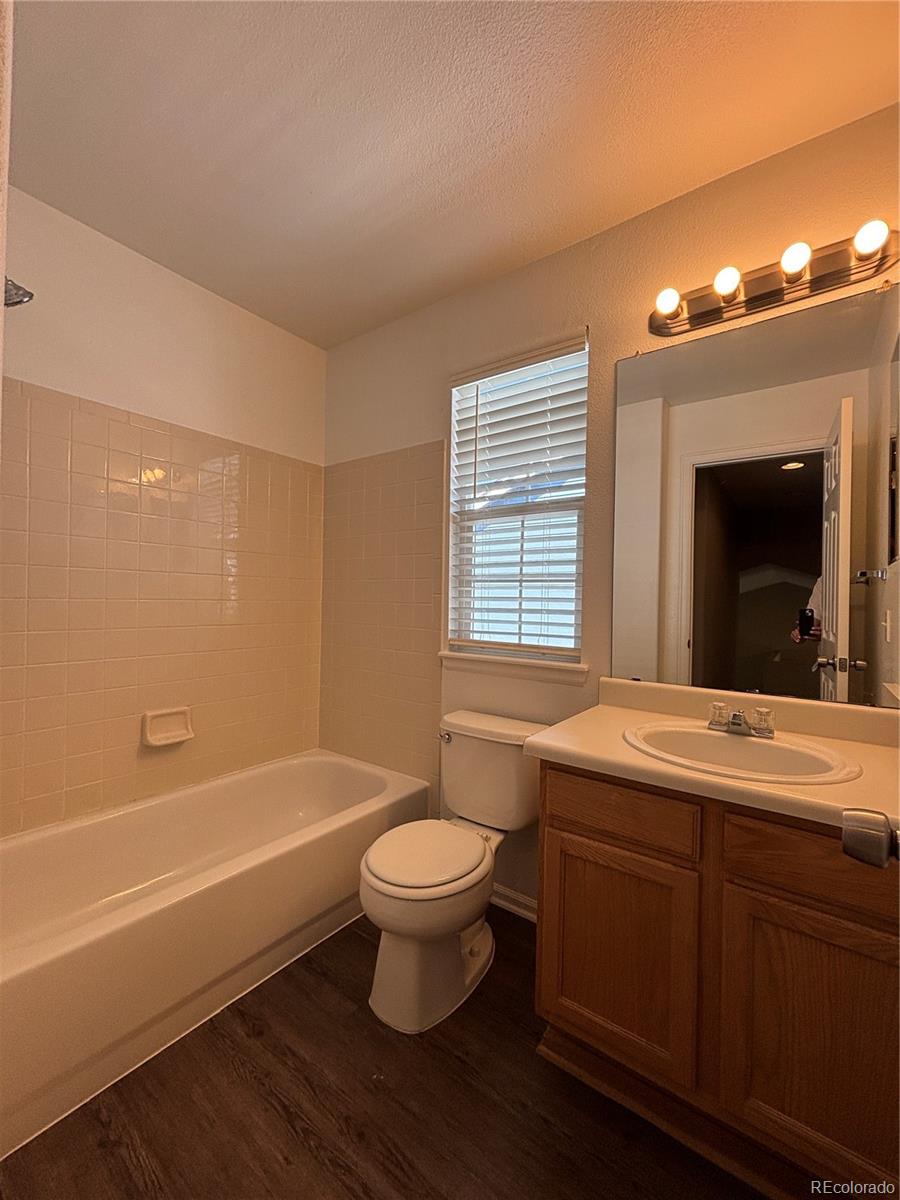 1281 Riddlewood Road Highlands Ranch, CO 80129 - Photo 19 of 27 a bathroom with a sink toilet a large mirror a bathtub and shower