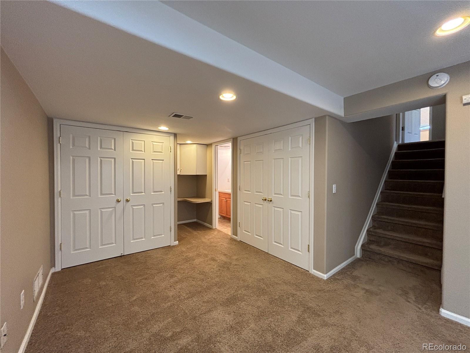 1281 Riddlewood Road Highlands Ranch, CO 80129 - Photo 23 of 27 a view of a livingroom with a staircase