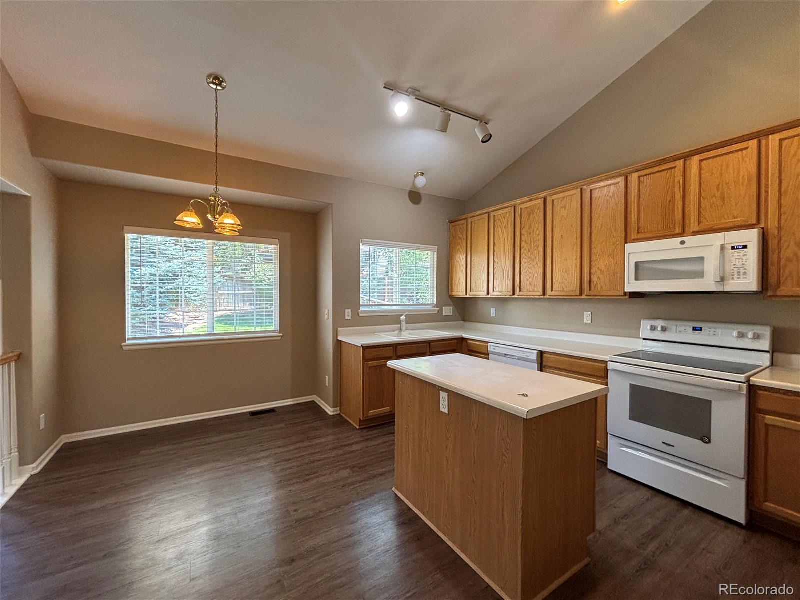 1281 Riddlewood Road Highlands Ranch, CO 80129 - Photo 5 of 27 a kitchen with a stove a sink and a window