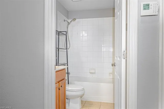 a bathroom with a bathtub shower sink vanity and toilet