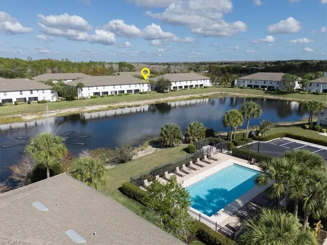 a aerial view of a house with swimming pool and a yard
