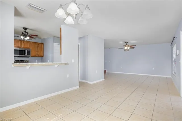 a view of a kitchen with a sink and a chandelier