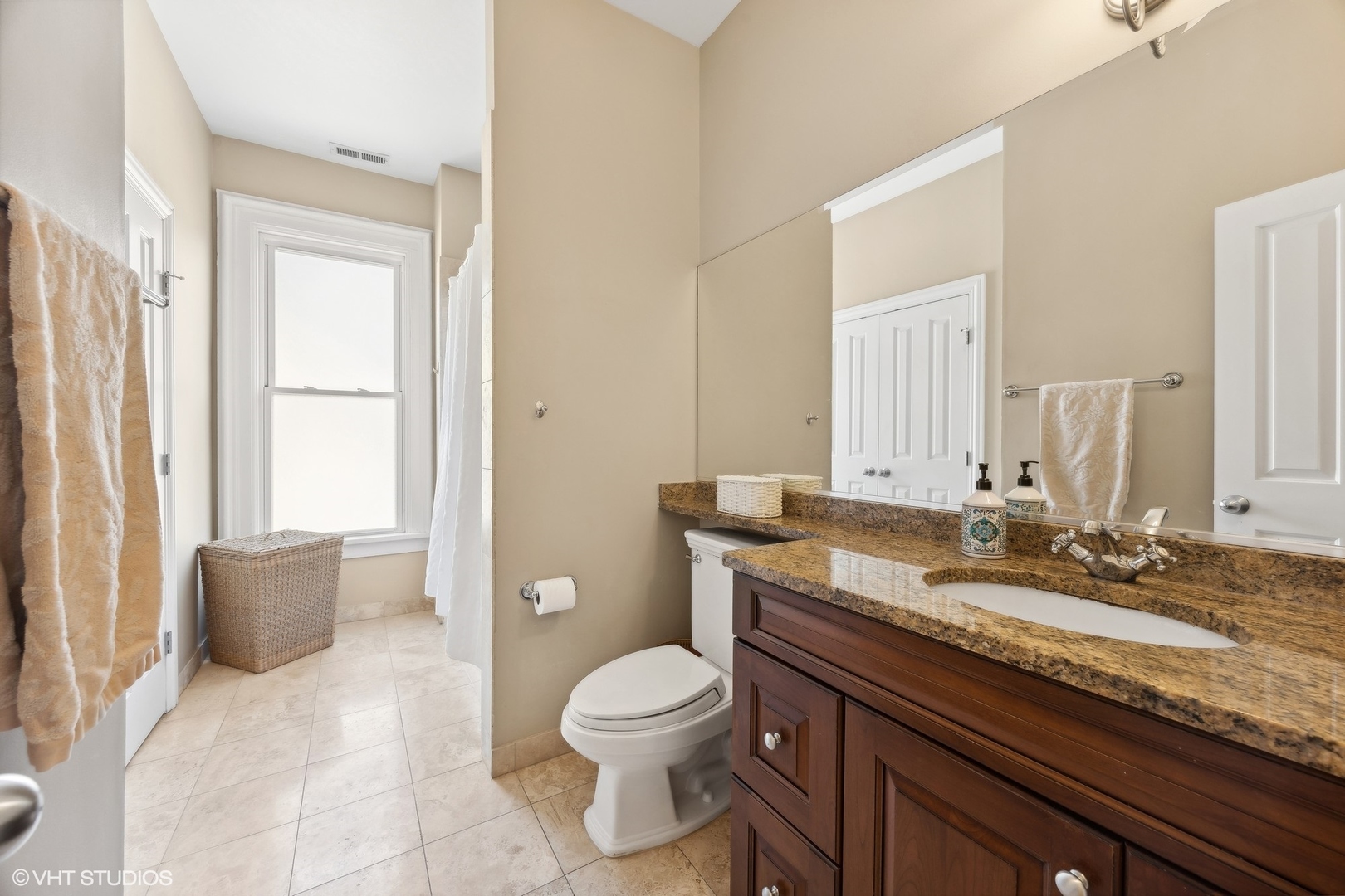 129 Barrypoint Road Riverside, IL 60546 - Photo 32 of 39 a bathroom with a granite countertop toilet a sink and a mirror
