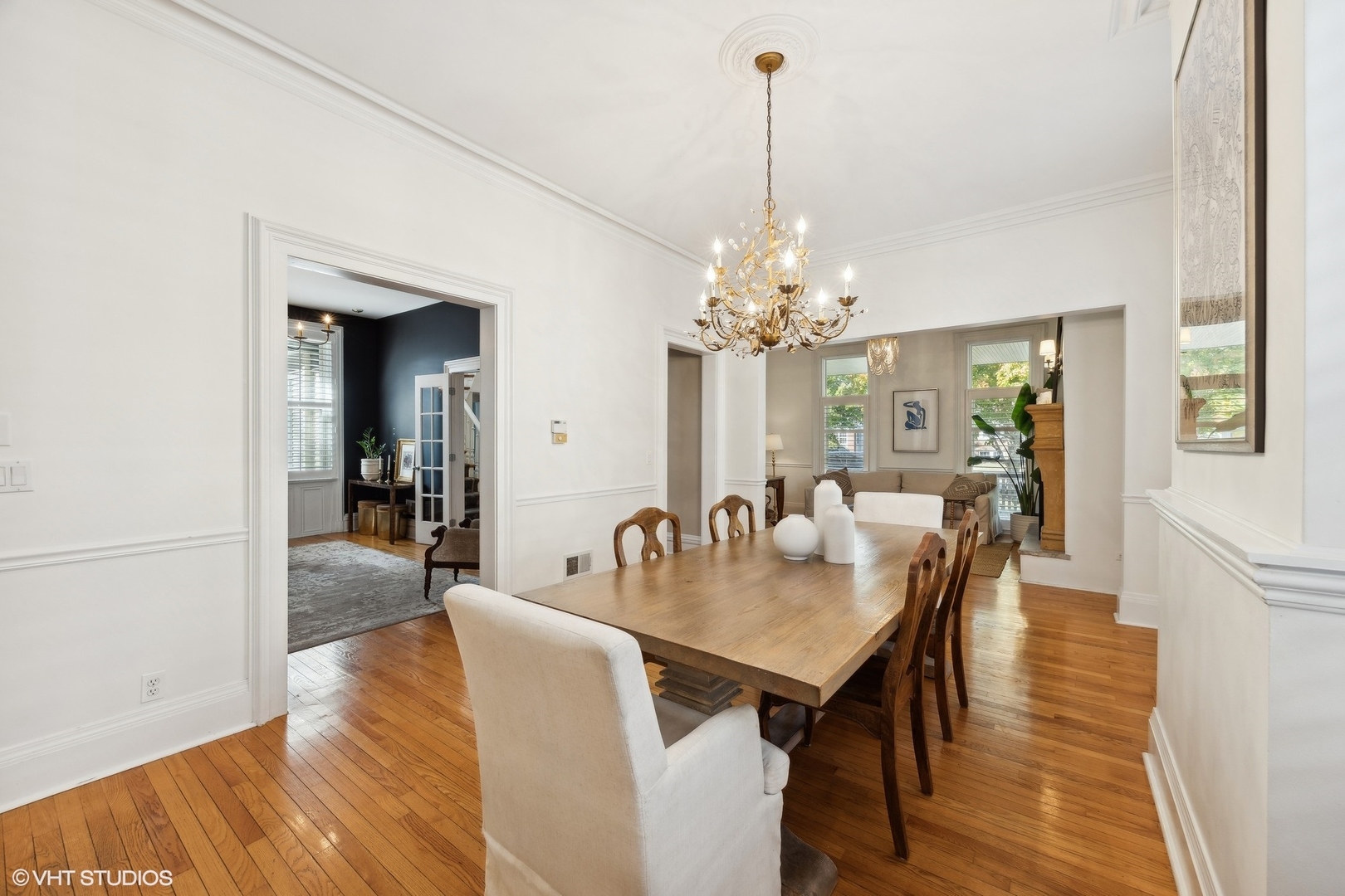 129 Barrypoint Road Riverside, IL 60546 - Photo 10 of 39 a view of a dining room and livingroom with furniture wooden floor a chandelier