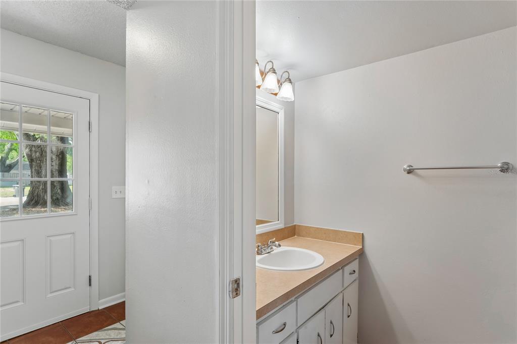 1907 Rambling Lane Brandon, FL 33510 - Photo 14 of 24 a bathroom with a sink and a mirror