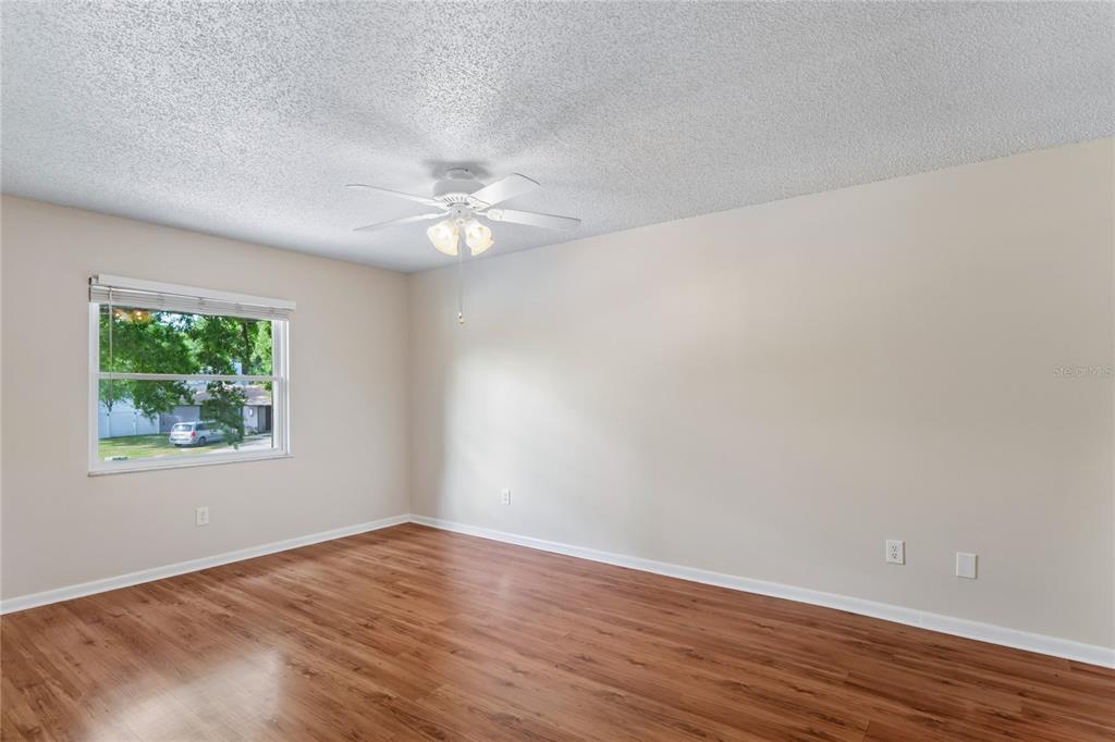 1907 Rambling Lane Brandon, FL 33510 - Photo 15 of 24 a view of an empty room with wooden floor and a window