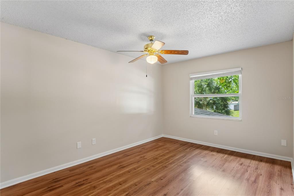 1907 Rambling Lane Brandon, FL 33510 - Photo 19 of 24 a view of an empty room with window and wooden floor