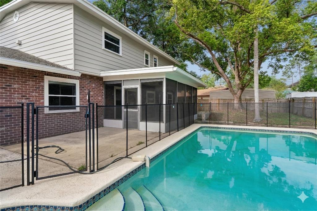 1907 Rambling Lane Brandon, FL 33510 - Photo 2 of 24 a view of backyard with large trees and wooden fence
