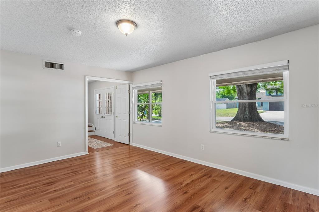 1907 Rambling Lane Brandon, FL 33510 - Photo 5 of 24 a view of an empty room with wooden floor and a window
