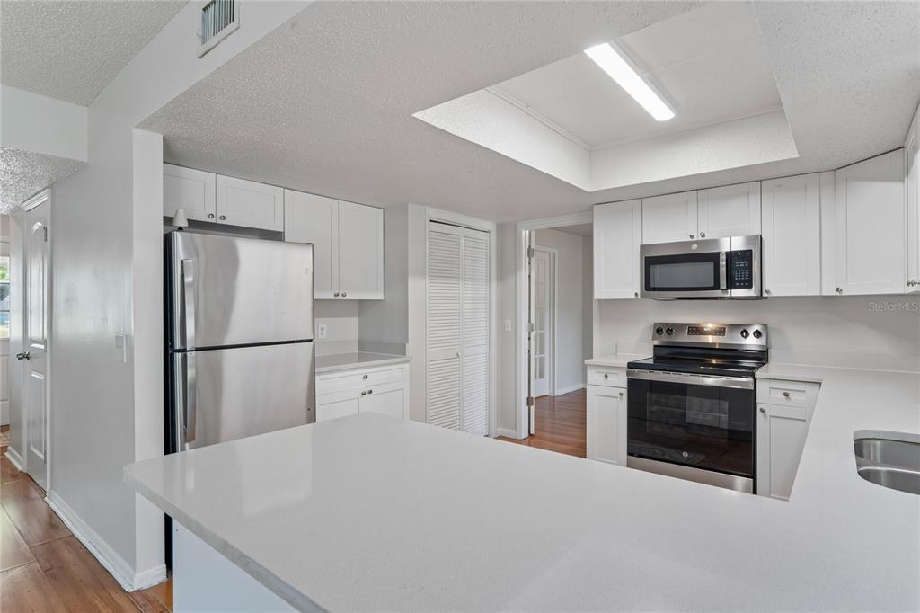 1907 Rambling Lane Brandon, FL 33510 - Photo 7 of 24 a kitchen with stainless steel appliances a refrigerator stove microwave and sink