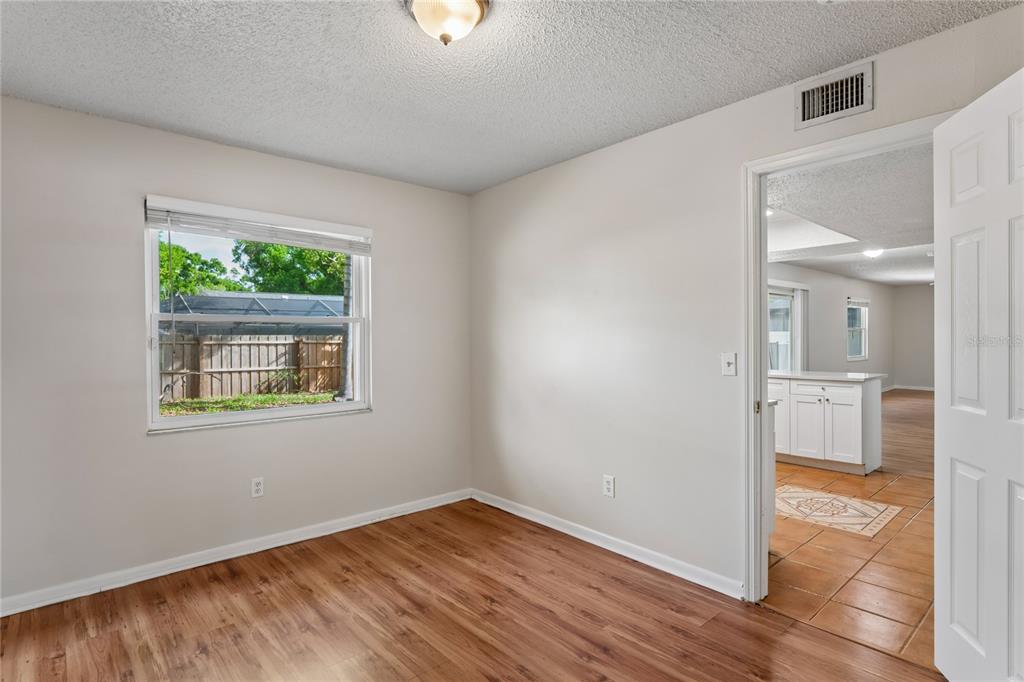 1907 Rambling Lane Brandon, FL 33510 - Photo 10 of 24 an empty room with wooden floor and a window