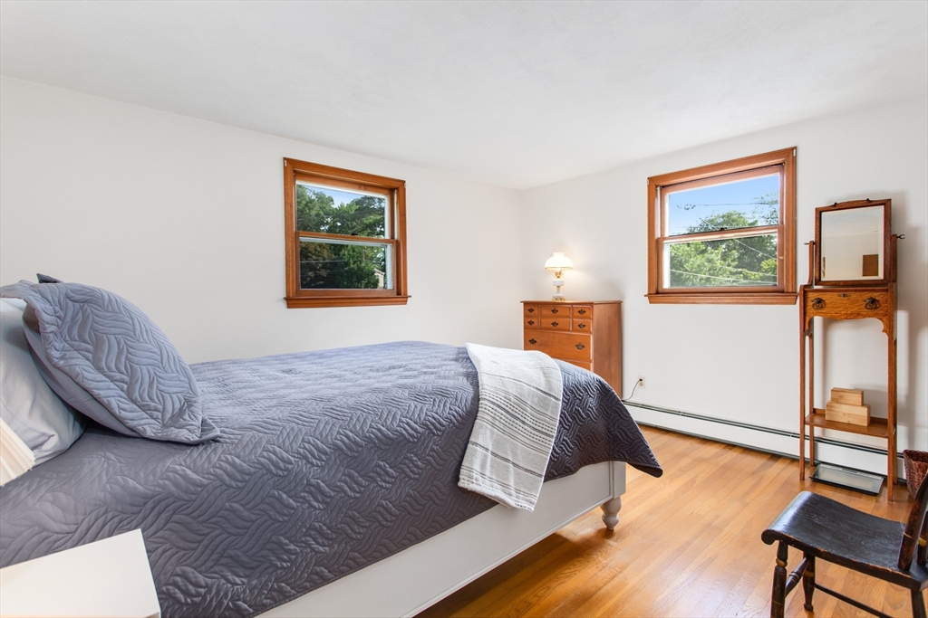 9 Hemlock Road Reading, MA 01867 - Photo 13 of 42 a bedroom with a bed and wooden floor