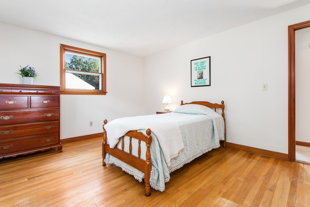 9 Hemlock Road Reading, MA 01867 - Photo 17 of 42 a bed room with a bed and a night stand