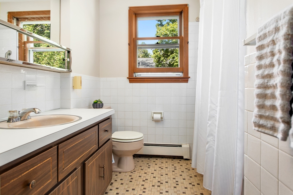 9 Hemlock Road Reading, MA 01867 - Photo 20 of 42 a bathroom with a sink toilet and window